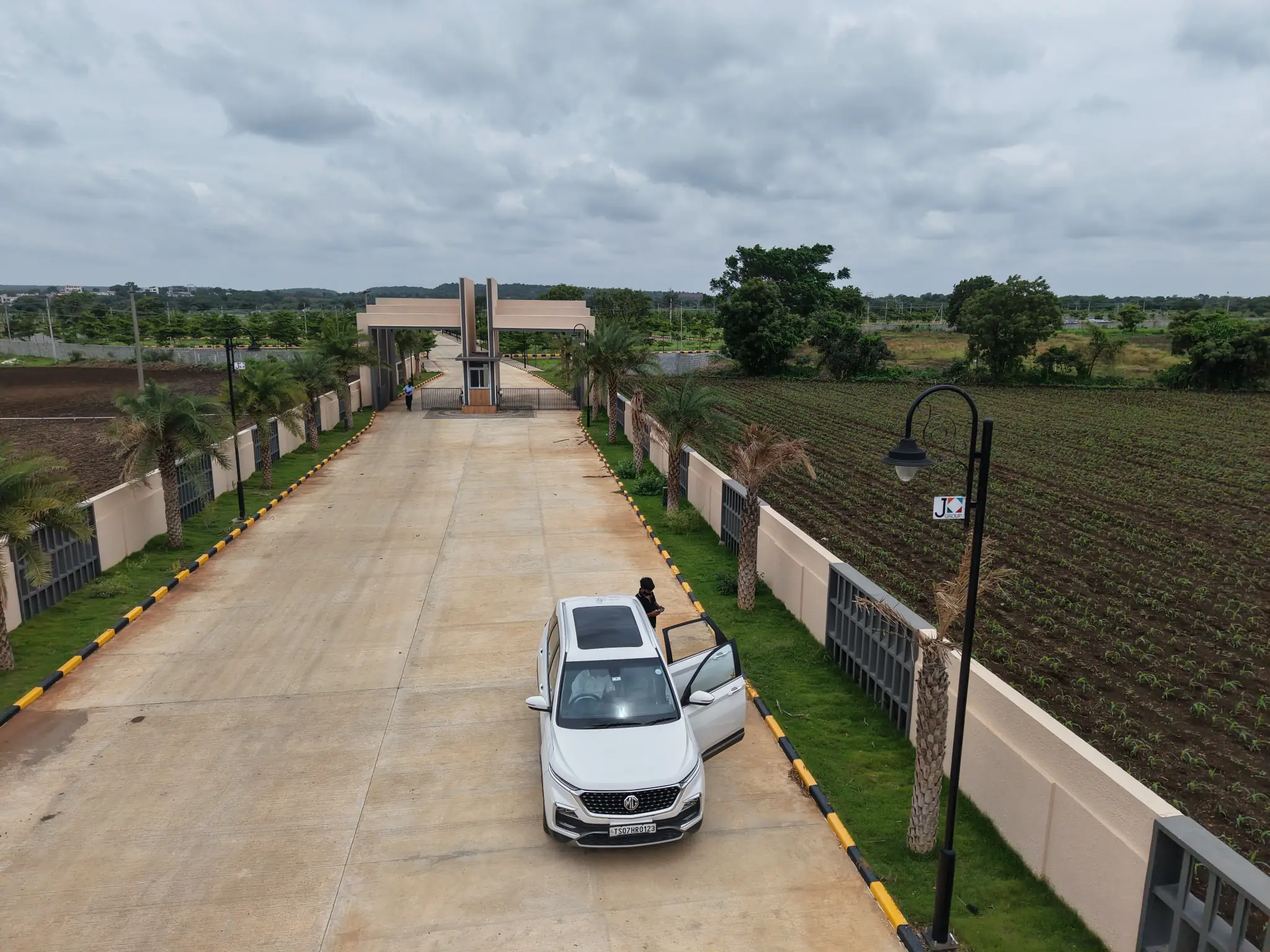 Wide internal road with streetlights at the Sahasra plotted development
