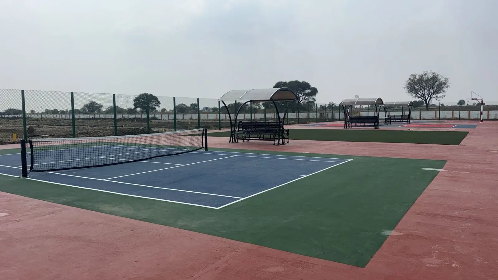 Tennis and basketball courts at Subhaga gated plotted community